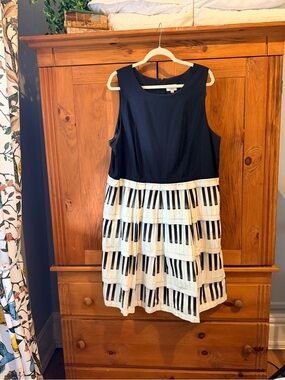 Sleeveless Black Dress with Piano-Print Tiered Skirt